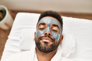 man-relaxed-with-facial-treatment-at-beauty-center.