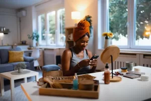 A woman wearing a turban is using her cell phone to communicate or access information.