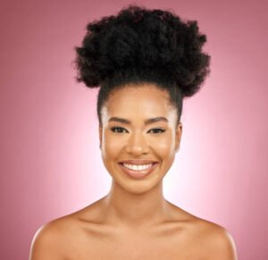 Smile, beauty and portrait of a woman for Maybelline skincare, wellness and dermatology glow. Happy, cosmetics and a headshot of a young girl or model with facial makeup isolated on a pink background in studio